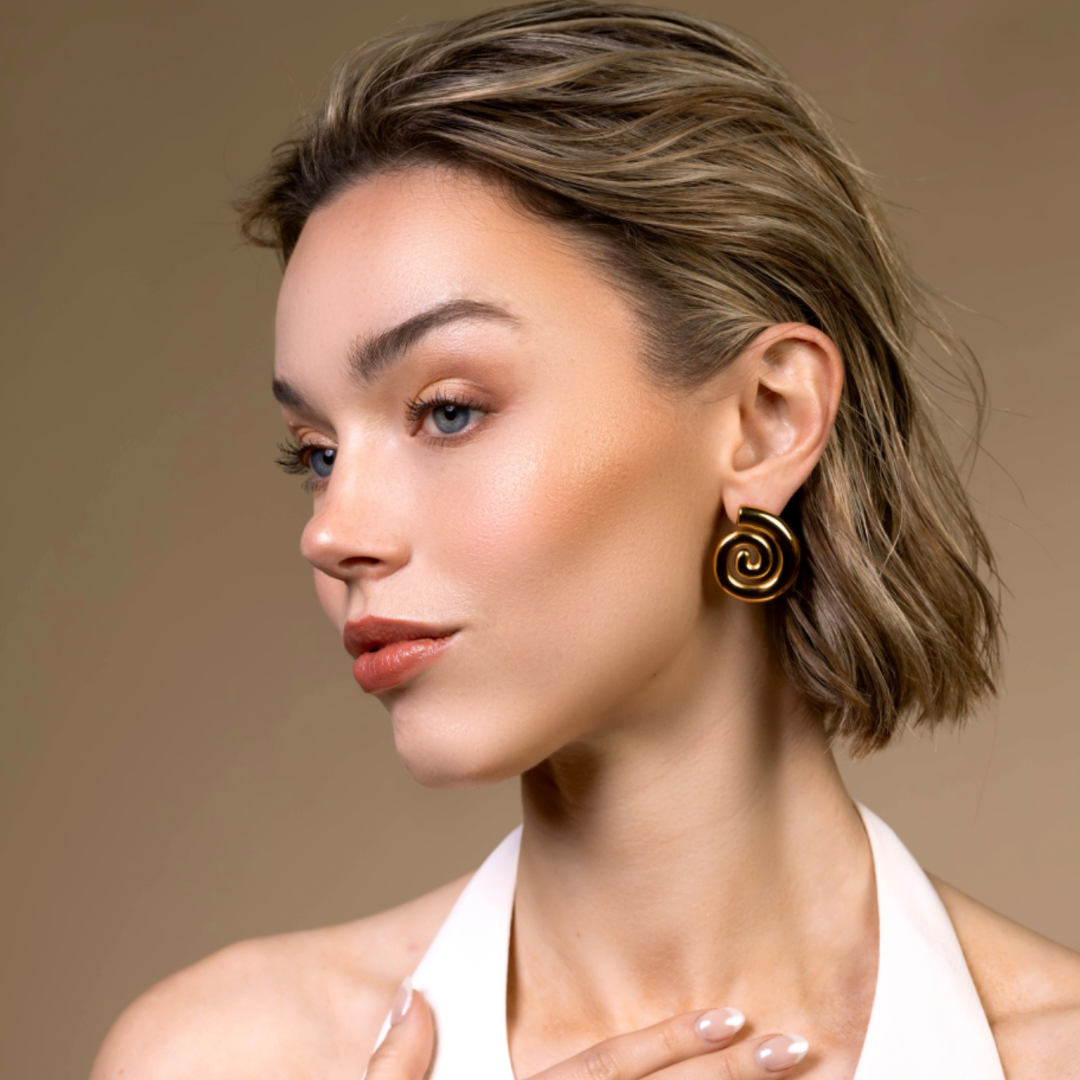 Cora spiral 18k gold hypoallergenic statement earrings seashell close up side model cover photo