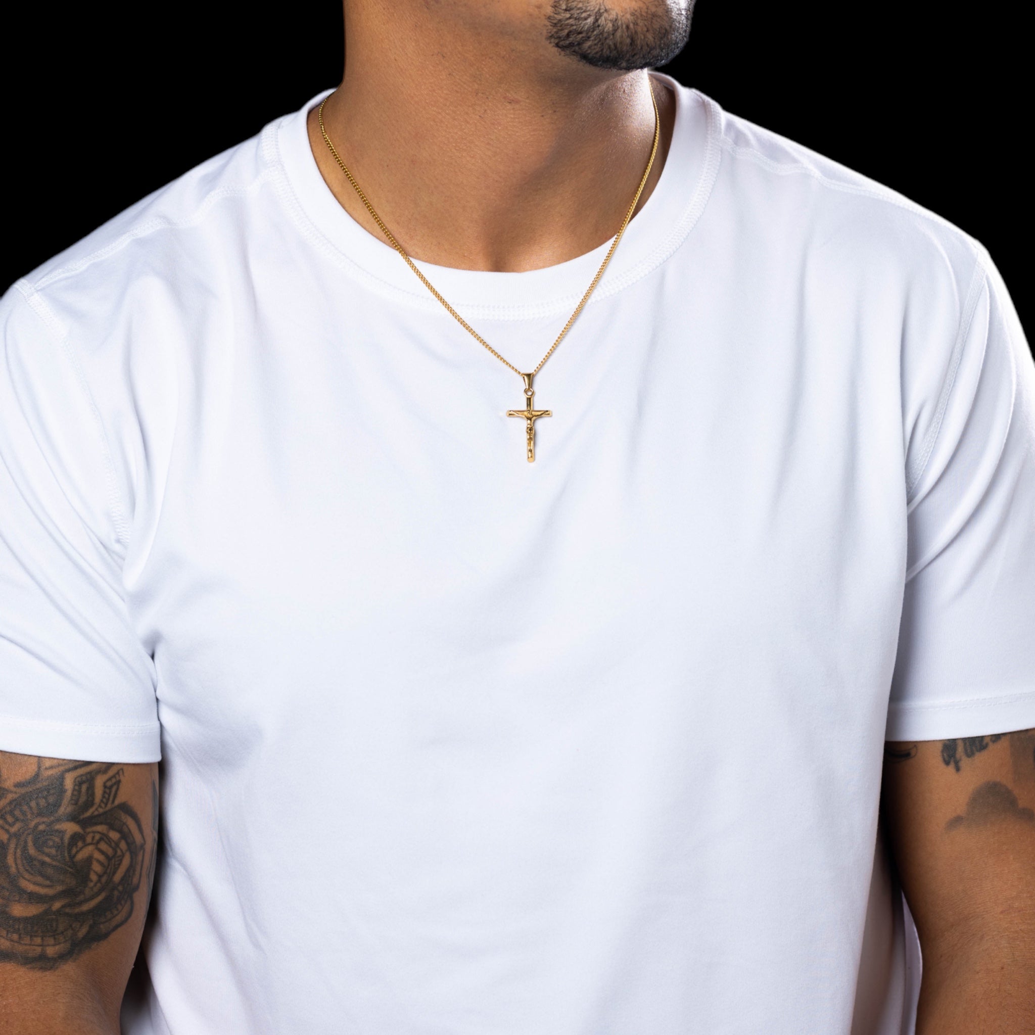 Gold crucifix jesus necklace 18 karat hypoallergenic with chain close-up photo jesus on a model detailed