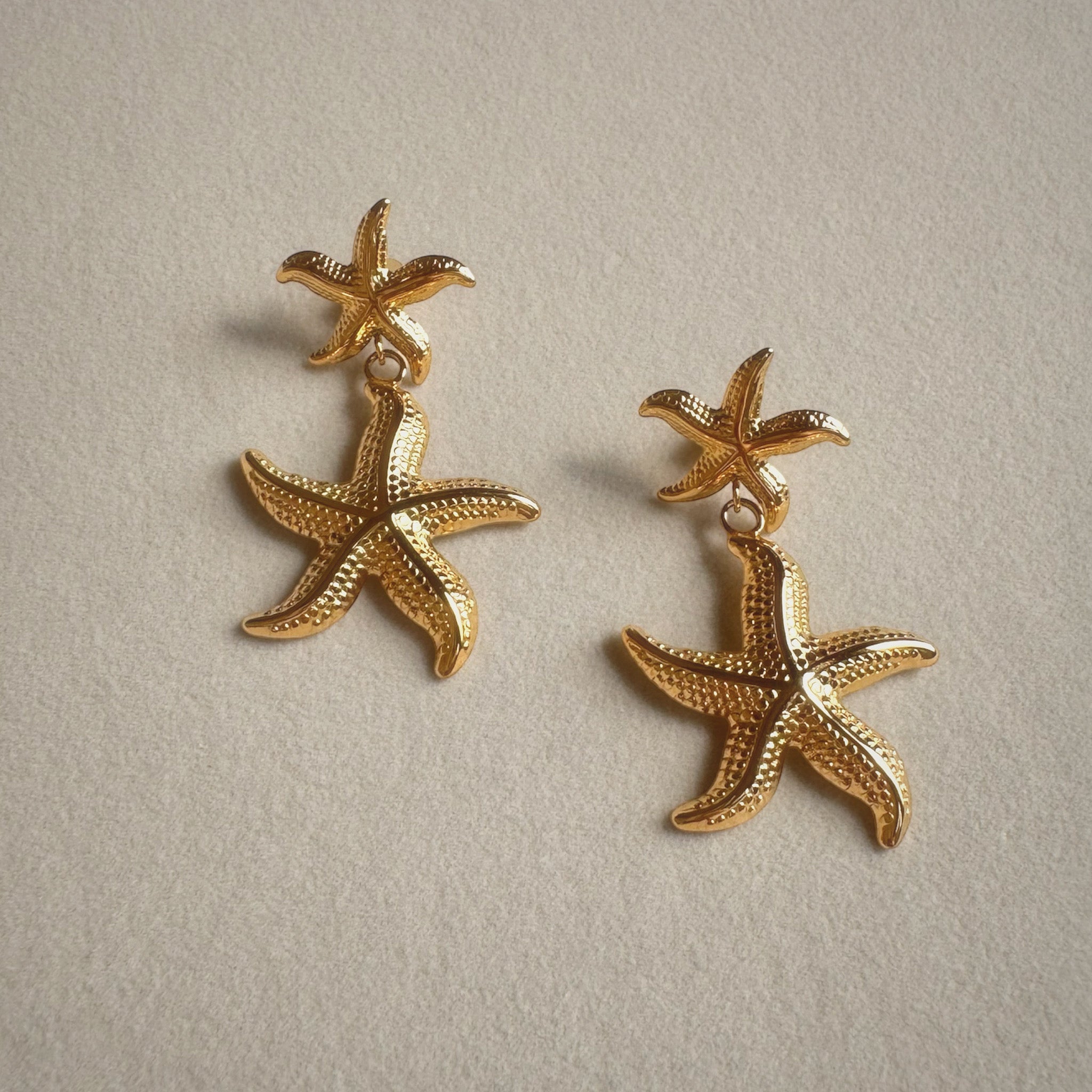 Calypso 18 karat hypoallergenic gold starfish dangle earrings detailed view